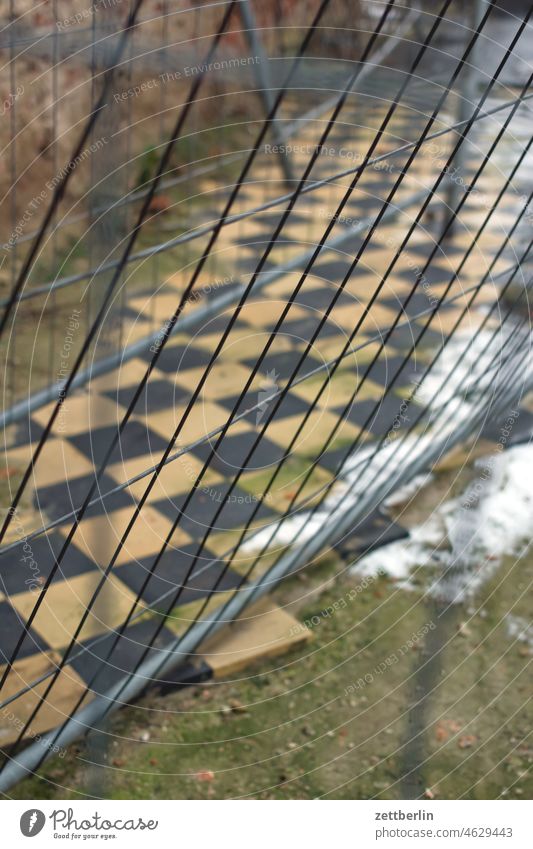 site fence Construction site Hoarding Fence Wire fence tiles floor tiles on the outside Winter Snow Chess Chessboard chequered pattern Depth of field