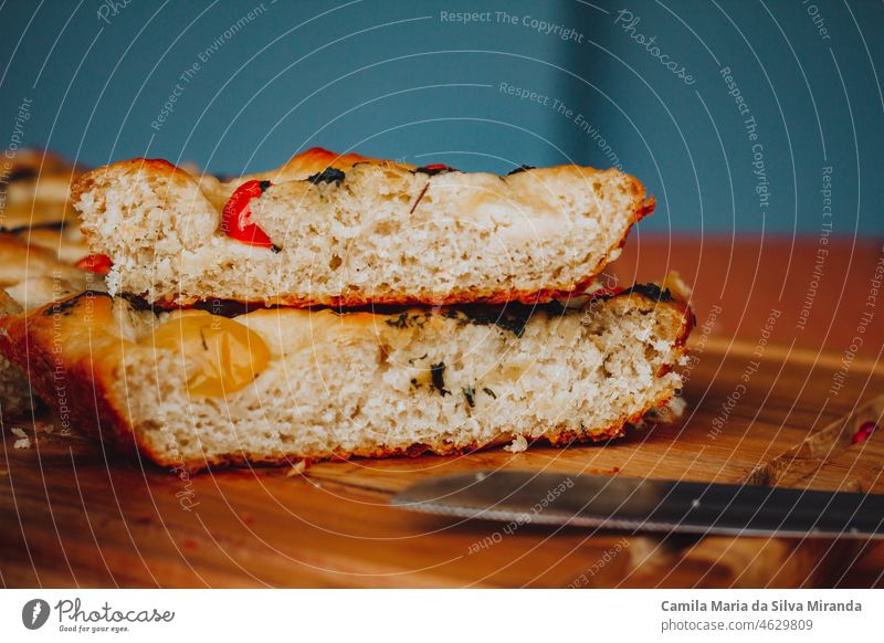 Homemade Italian Focaccia, with tomato and olive oil on a rustic wooden background. appetizer bake baked bakery black background bread cherry tomatoes closeup