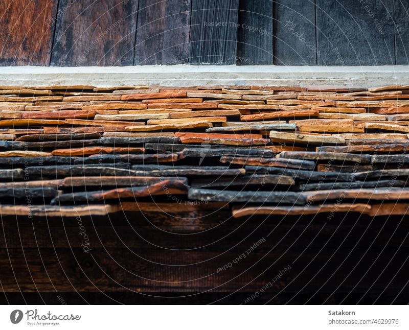 The ancient building roof was shingled with warped clay tiles texture pattern old material architecture traditional house background brown structure detail