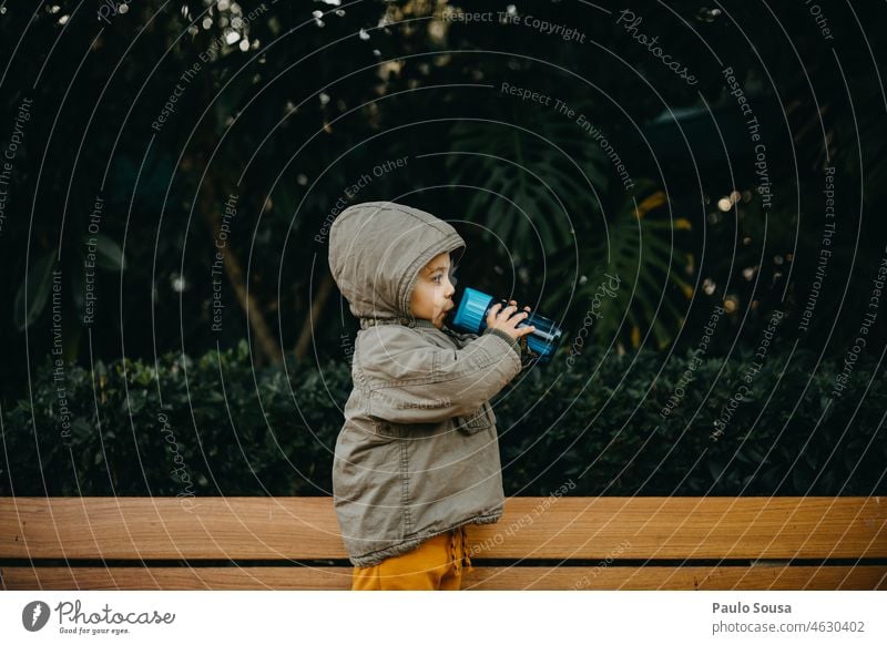 Side view of child drinking water from bottle Child childhood 1 - 3 years Caucasian one person side view Drinking Boy (child) Bottle Water Exterior shot Joy Day