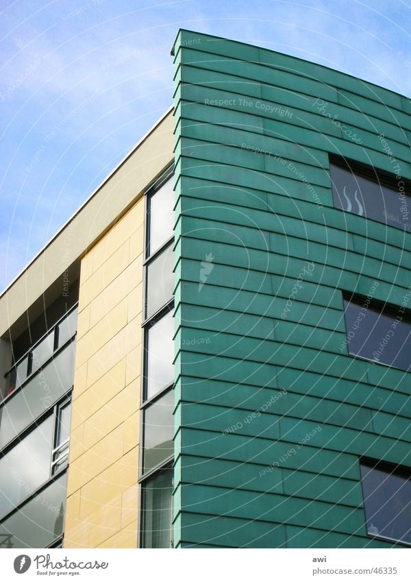 Yellow-Green-Blue Facade High-rise Window Clouds Detail Sky Front side Town Architecture