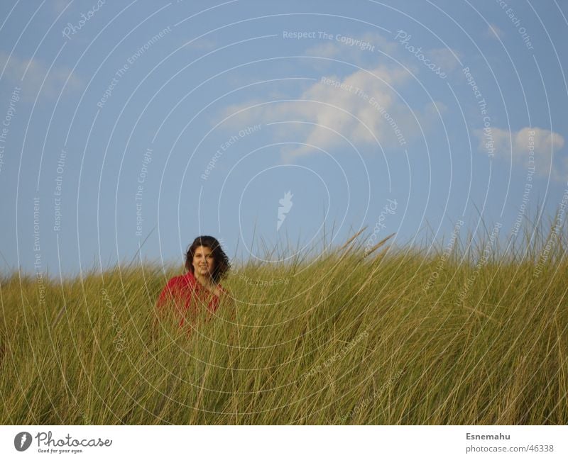 With your back to the sea Clouds Grass Woman Red Green Brown Loneliness Sweater Sky Meadow Blue Human being Wind Hair and hairstyles Colour Clouds in the sky