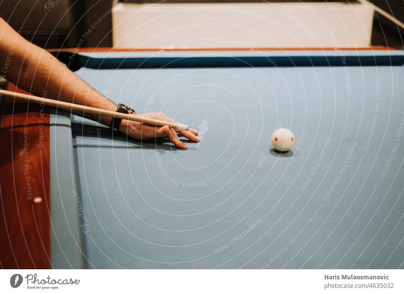 hand aiming to hit white ball in billiard activity background black chalk challenge closeup colorful competition competitive cue cushion entertainment fun