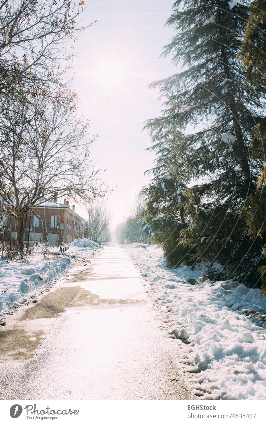 Icy road and street after heavy snowfall. Winter weather icy winter weather snowing wintertime season outdoor ice cold blizzard frost city white snowy travel