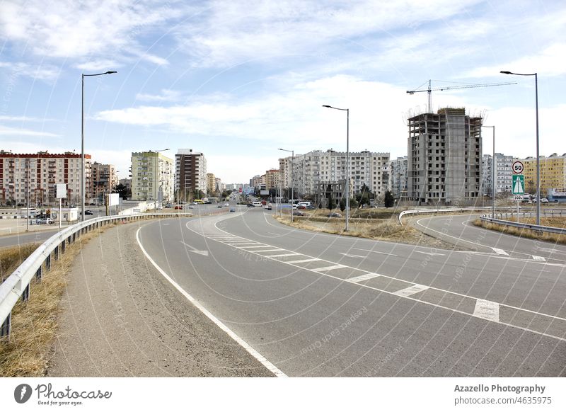 Main entrance road to the town apartment architecture arrival asphalt background block blue building building construction city cityscape clouds cloudscape