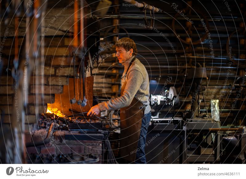 Blacksmith at work, hit with a hammer by a hot metal on the anvil. blacksmith forge fire molten tongs bright craft equipment farrier glowing heat heavy