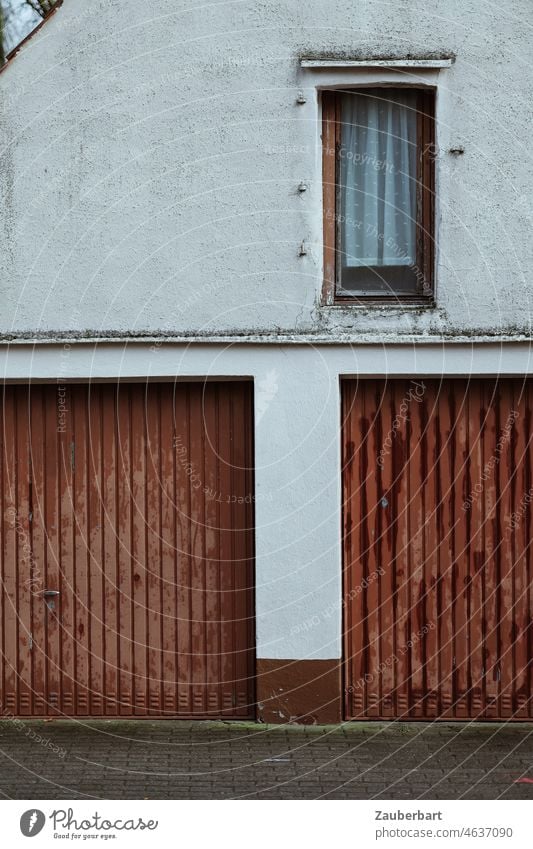 Garage doors and windows on the facade of an older house Highway ramp (entrance) double garage Window Facade Brown White Small Town Curtain Old transient