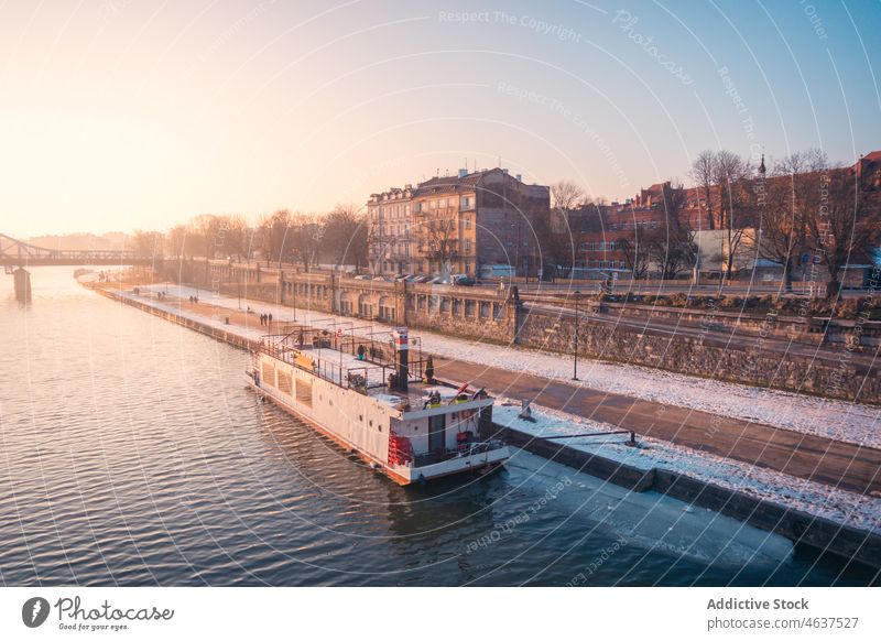 Ship on river near snowy coast water ship vessel embankment waterfront winter city cruise frost hoarfrost building cold moor freeze frozen waterside house