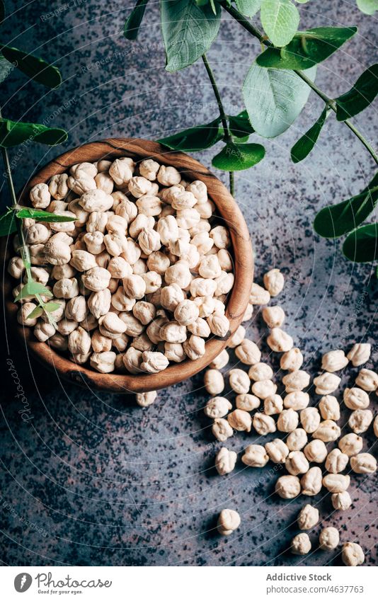 Heap of dry chickpeas in bowl legume culinary kitchen organic food raw uncooked healthy food product table fresh natural ingredient cuisine many light heap