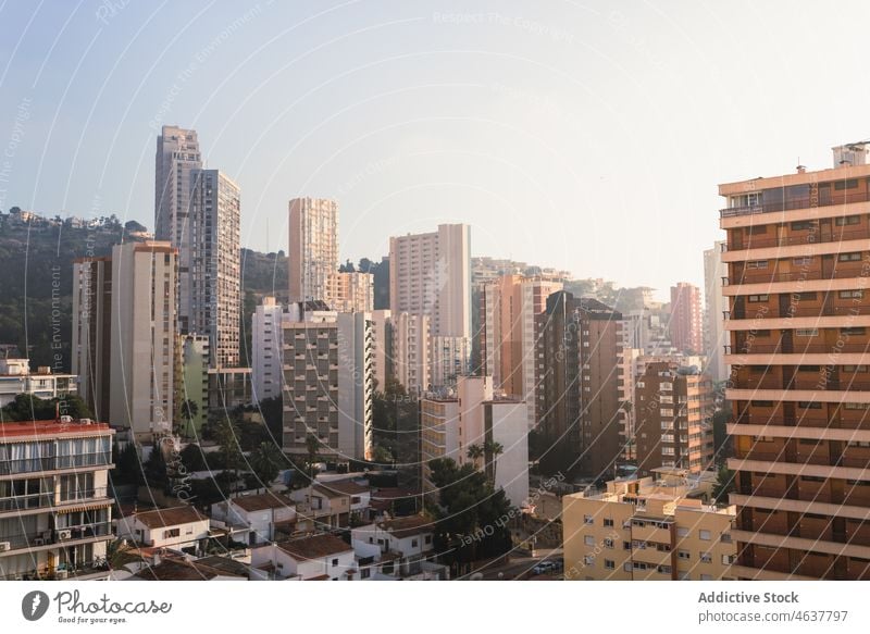 Cityscape with modern buildings at hillside under blue sky city cityscape district architecture exterior urban facade infrastructure residential multistory