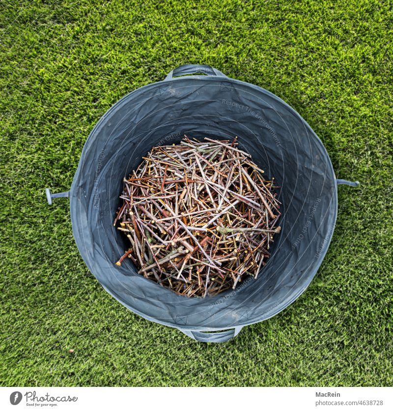 Woodcut in a waste bag rubbish sack Day top view Exterior shot branches color photograph Shredded Green green waste wood pieces Compost Nature nobody Lawn