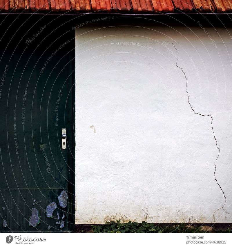 Partial view facade - tracks Wall (building) Facade Building Crack & Rip & Tear Roof Roofing tile Old door Door lock Wood Metal White Black Red blades of grass