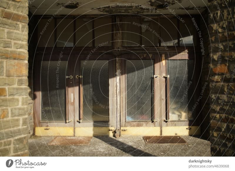 Entrance to an old building, lost place architecture with sunlight, unfinished and authentic made of quarry stone, wood, brass and glass Architecture Redecorate