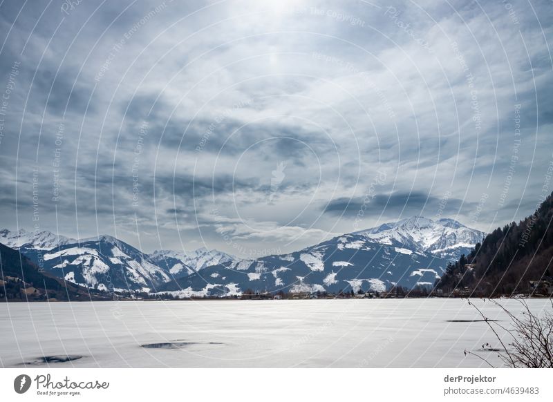 View of snow covered peaks and frozen lake Snowscape Mountain range Panorama (View) Long shot Deep depth of field Sunlight Light (Natural Phenomenon) Reflection