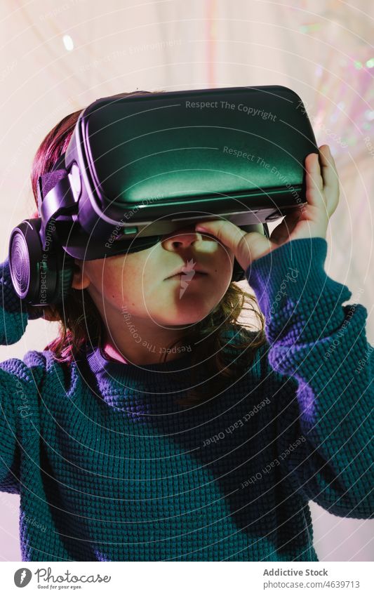 Girl exploring cyberspace in VR glasses child virtual reality explore girl experience vr goggles kid headset gadget device innovation digital futuristic