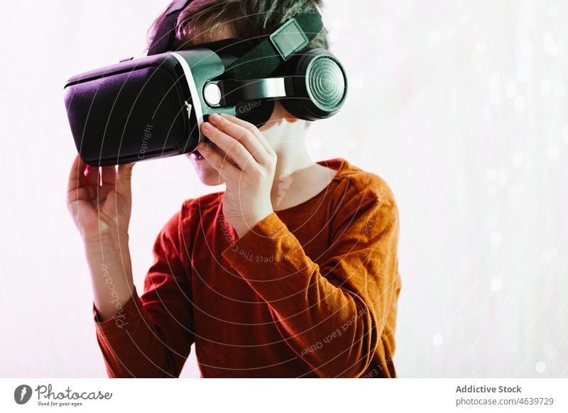 Boy exploring cyberspace in VR glasses child virtual reality explore boy experience vr goggles kid headset gadget device innovation digital futuristic simulate