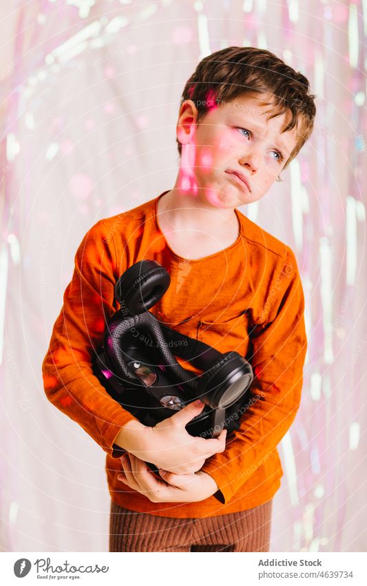 Cute boy with VR headset in studio child vr glasses upset goggles cute little kid cyberspace unhappy disappointed virtual reality sad device gadget childhood