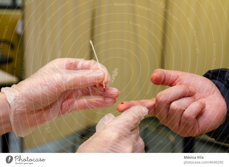 They collect blood from a patient's finger to do the covid test sars covid 19 coronavirus blood sample gloved hand nurse ill disease pandemic covid-19 medical