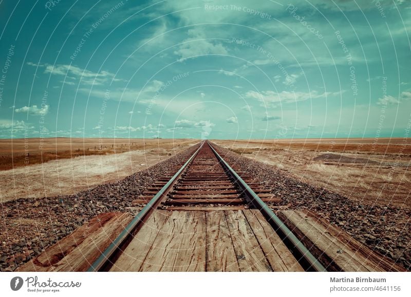 Straight rail track in the wide lands of Montana montana western usa tracks forward landscape travel transportation nature railroad journey railway iron