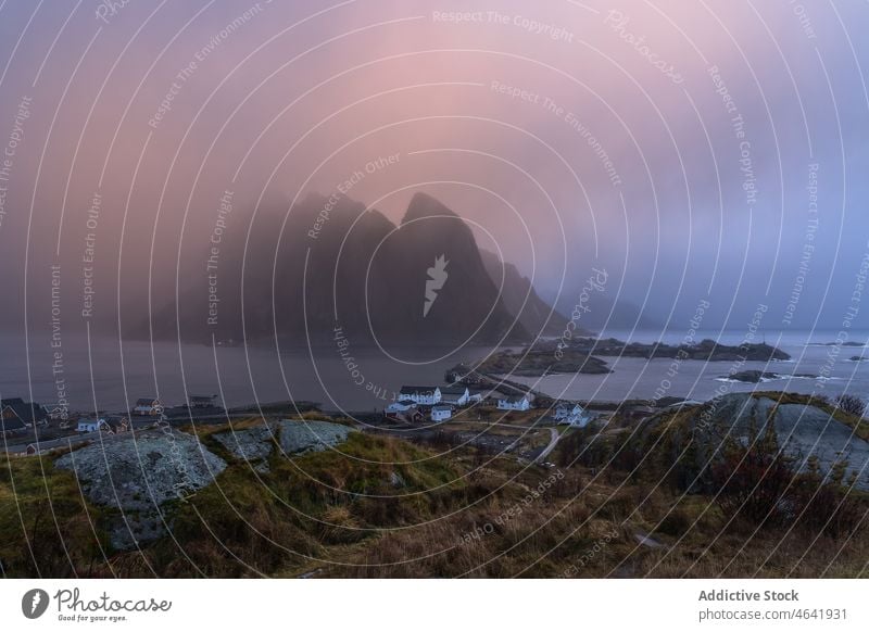 Breathtaking view of rocky seashore in mist mountain landscape fog water sky scenic lofoten norway island picturesque scenery sunrise majestic nature coast