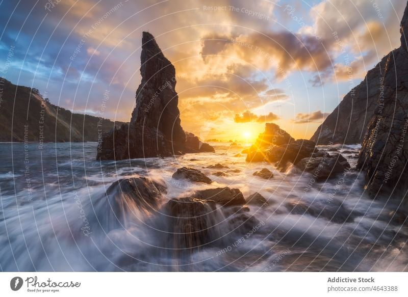 Rocky formations in flowing sea rock cliff water nature stone mountain sunset rocky sundown sunrise seawater asturias spain rough cloudy playa del silencio