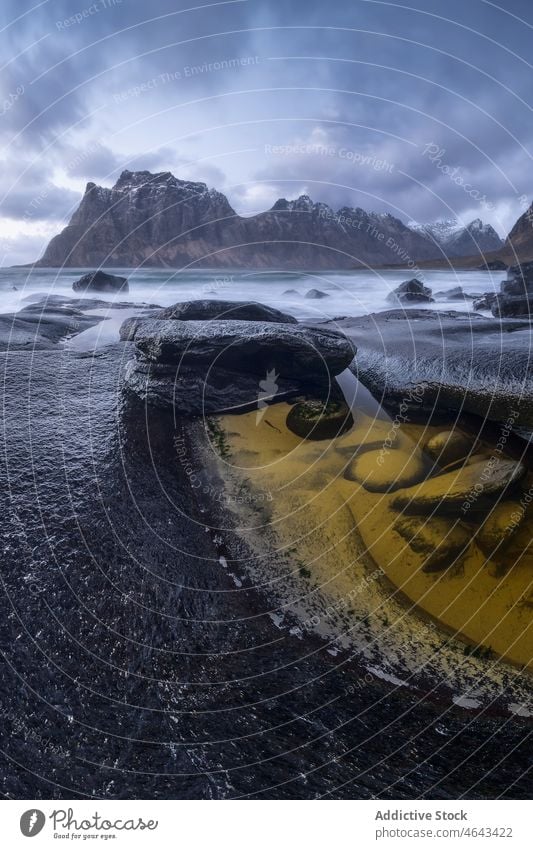 Sea in archipelago in Norway sea flow mountain snow water nature overcast rock winter boulder environment scenery marine natural scenic norway lofoten aqua