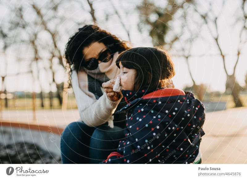 Mother cleaning daughter's nose motherhood Girl two people Family & Relations Lifestyle Child girl Caucasian Happy Woman care 30 - 45 years 3 - 8 years Together