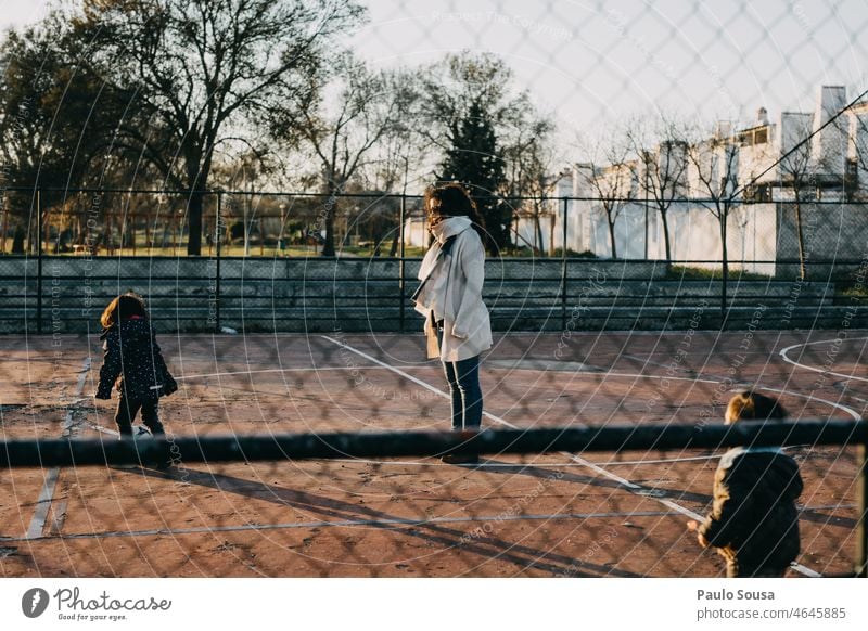 Mother with children playing football motherhood three people Child Family & Relations Lifestyle care Parents Love togetherness Happy Woman having fun