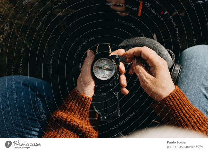 Woman using compass navigation Compass (Navigation) Compass point Colour photo Orientation Direction Target Hiking Adventure Day Exterior shot Mountain