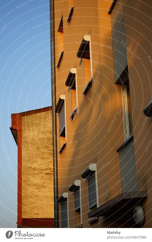 Facade of a residential building in beige and natural colors in the light of the evening sun in the evening in the Bornheim district of Frankfurt am Main in the German state of Hesse