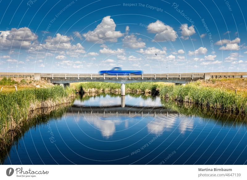 Small bridge on the highway in Montana, a car passing by tranquility reflection beauty rural landscape truck motion blur montana logistic lorry transportation