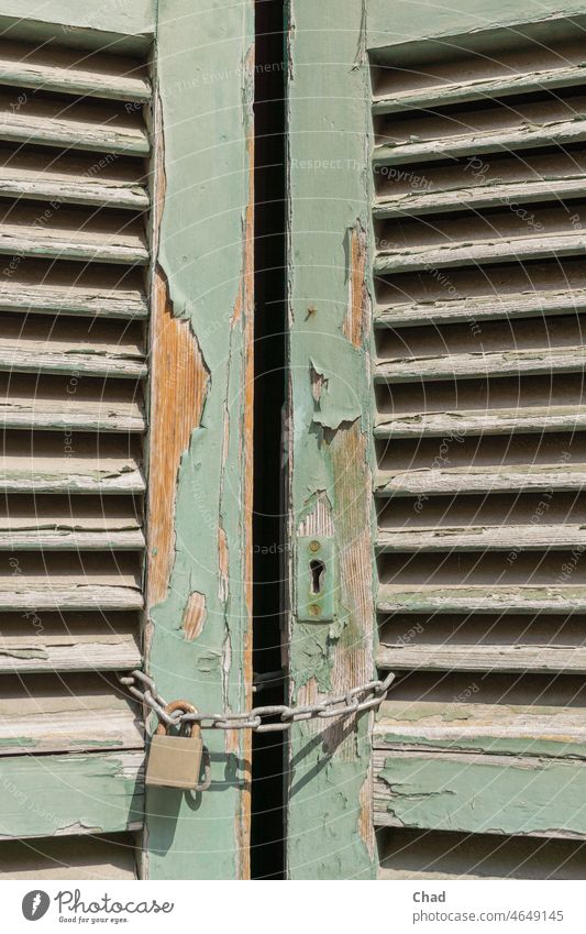 Old door shutter with padlock lost place folding shutter transient Transience Architecture Door shutter Derelict dilapidated Ravages of time M Deserted morbid