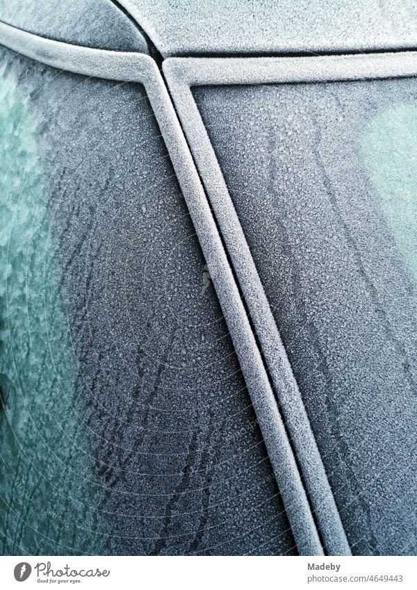 Due to hoar frost in winter iced windows of an old car with trim in winter in Oerlinghausen near Bielefeld on the Hermannsweg in the Teutoburg Forest in East Westphalia-Lippe