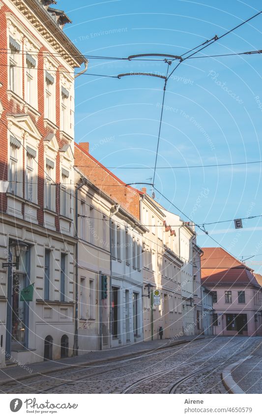 Where is everybody? Street Tram lines Overhead line Sky Blue Deserted Public transit Traffic infrastructure Rail transport Facades Housefront Old town Town