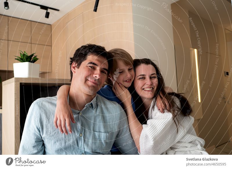 Happy family. .Mom, dad and son at home in the kitchen. Hugs and kisses. Good morning love happy father mother child kids mom smile woman girl boy daughter