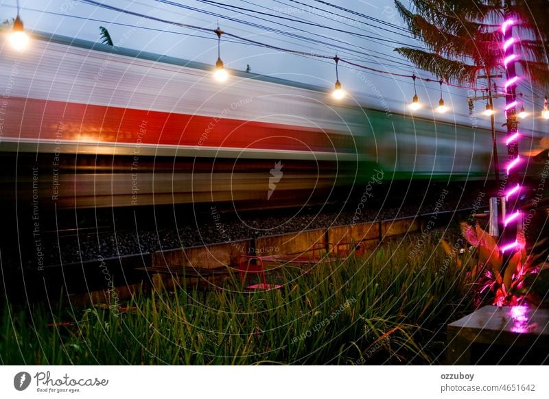 Passenger train moves fast at sunset time. on the move. transport motion speed railroad railway moving station transportation locomotive line blur journey