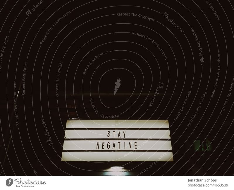 Stay negative as writing on a light box at night coronavirus pandemic black-and-white Negative Risk of infection dislike Epidemic embassy Word Exhaustion