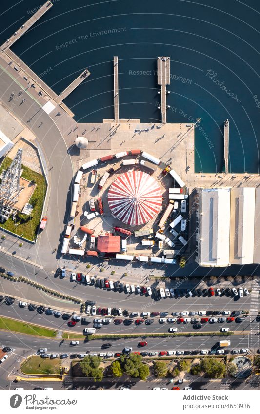 Amusement park near sea in city amusement attraction public road car water waterside street summer fairground vehicle parked modern auto transport district