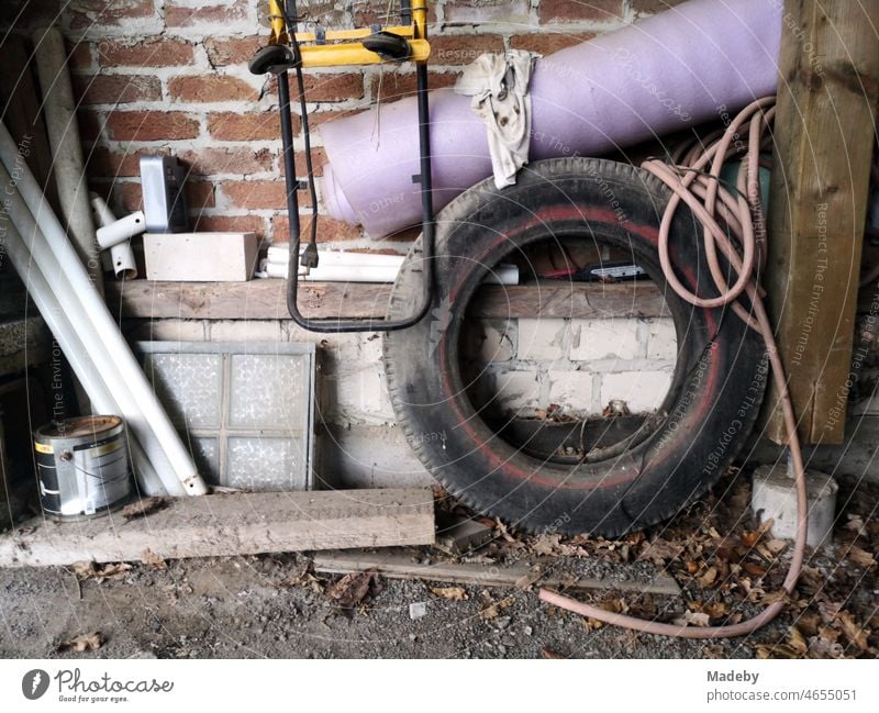 Old car tires, junk and bulky waste in an old garage in Oerlinghausen near Bielefeld on the Hermannsweg in the Teutoburg Forest in East Westphalia-Lippe Garage