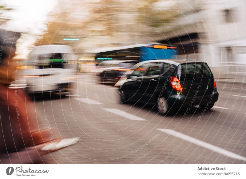 Blurred cars driving on road drive street pedestrian asphalt city traffic transport vehicle urban roadside ride auto motion move route commute roadway autumn