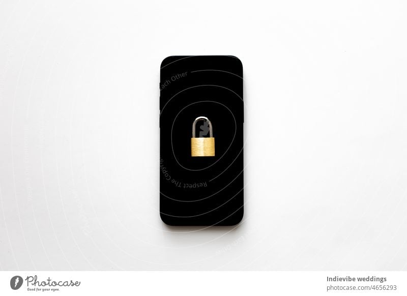 An isolated black smartphone with a small padlock on it on white background. Phone protection idea. Online data privacy protection concept. Protection against cyber attack.