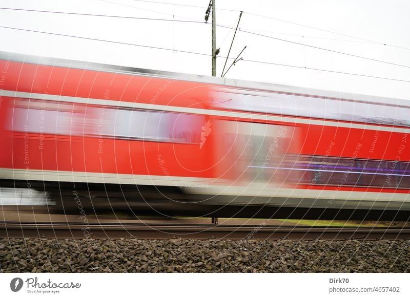 Regional express train in fast motion Track Train travel Railroad Railroad car railcar Driving Trip Speed Dynamic motion blur motion blurred Rail transport