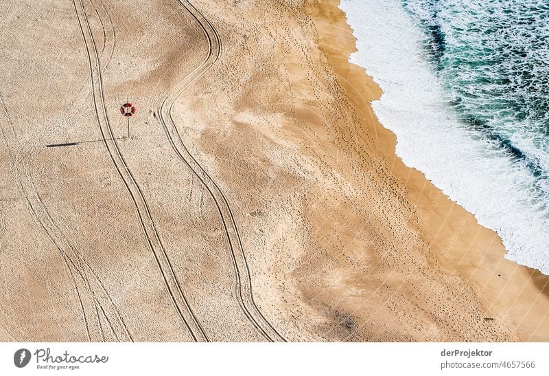 Tracks in the beach with sea in Nazaré in Portugal I Nature Environment abandoned place forsake sb./sth. coast Ocean Emotions Loneliness Gray Gloomy