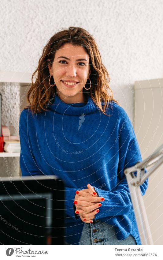 Portrait of a smiling girl in the creative studio where she works young women desk agency creativity designer entrepreneur lifestyles looking at camera company