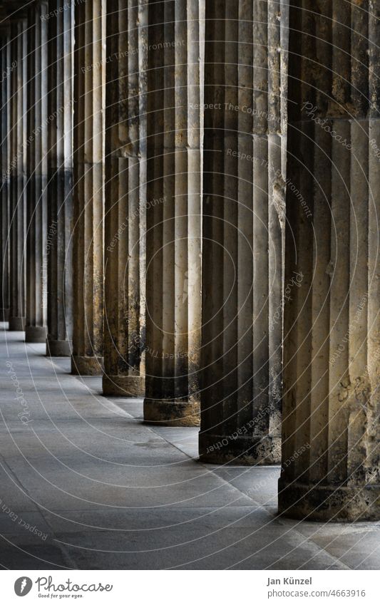 Colonnades on the Berlin Museum Island repeat columns portico Museum island Downtown Berlin Architecture architectonically Geometry geometric Perspective Brown