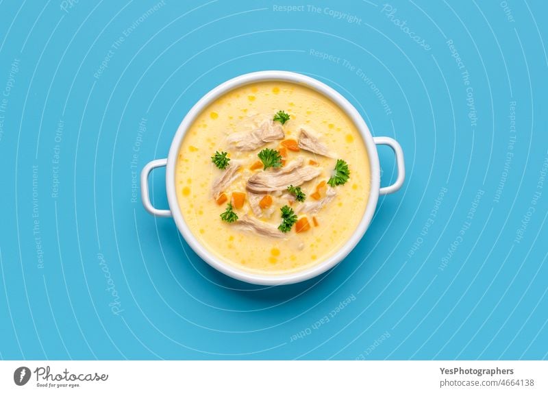 Greek chicken soup avgolemono, above view on a blue background. bowl bright carrots citrus color creamy cuisine delicious dinner dish egg enamel european fat