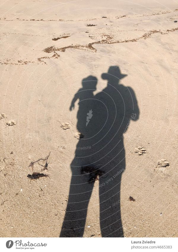 Shadow of mum and baby motherhood Mother Child Parents Woman Together Holding Family Beach Dog paws Sun Sunlight Sand Happy Love people care Beautiful