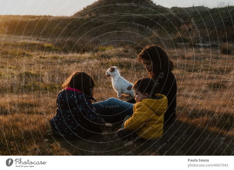 Family sitting outdoors with dog Family & Relations Mother motherhood Child childhood Caucasian Infancy Parents Happy Lifestyle Together Woman people care Love