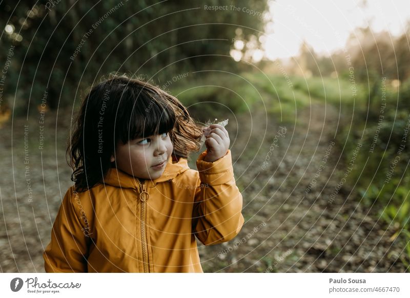 Cute girl holding hair Girl 3 - 8 years Caucasian Child Infancy Human being European kid Schoolchild Exterior shot White Hair and hairstyles Nature Colour photo