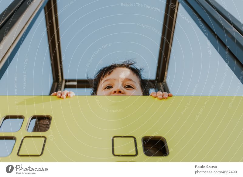 Child peeking childhood Boy (child) Close-up Eyes peek a boo Portrait photograph Looking outdoors park Face Colour photo real people Authentic Playing